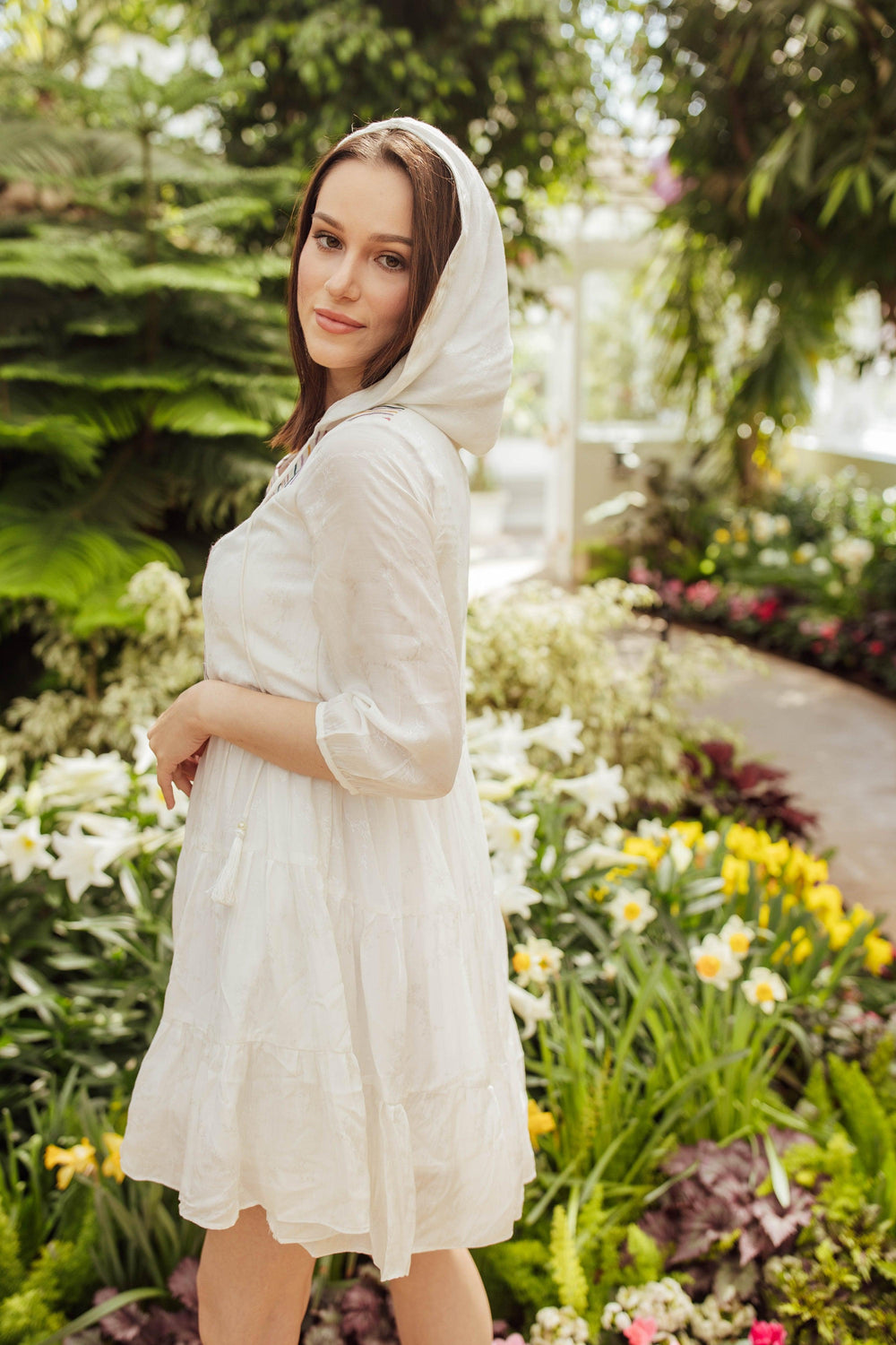 White cotton short dress with hood, 3/4 sleeves, tiered silhouette, and resham embroidery.
