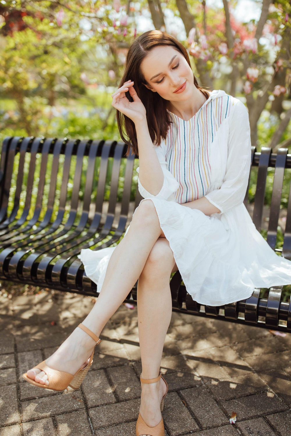White tiered mini dress with colorful resham embroidery, 3/4 sleeves, and a hood, worn by a model.