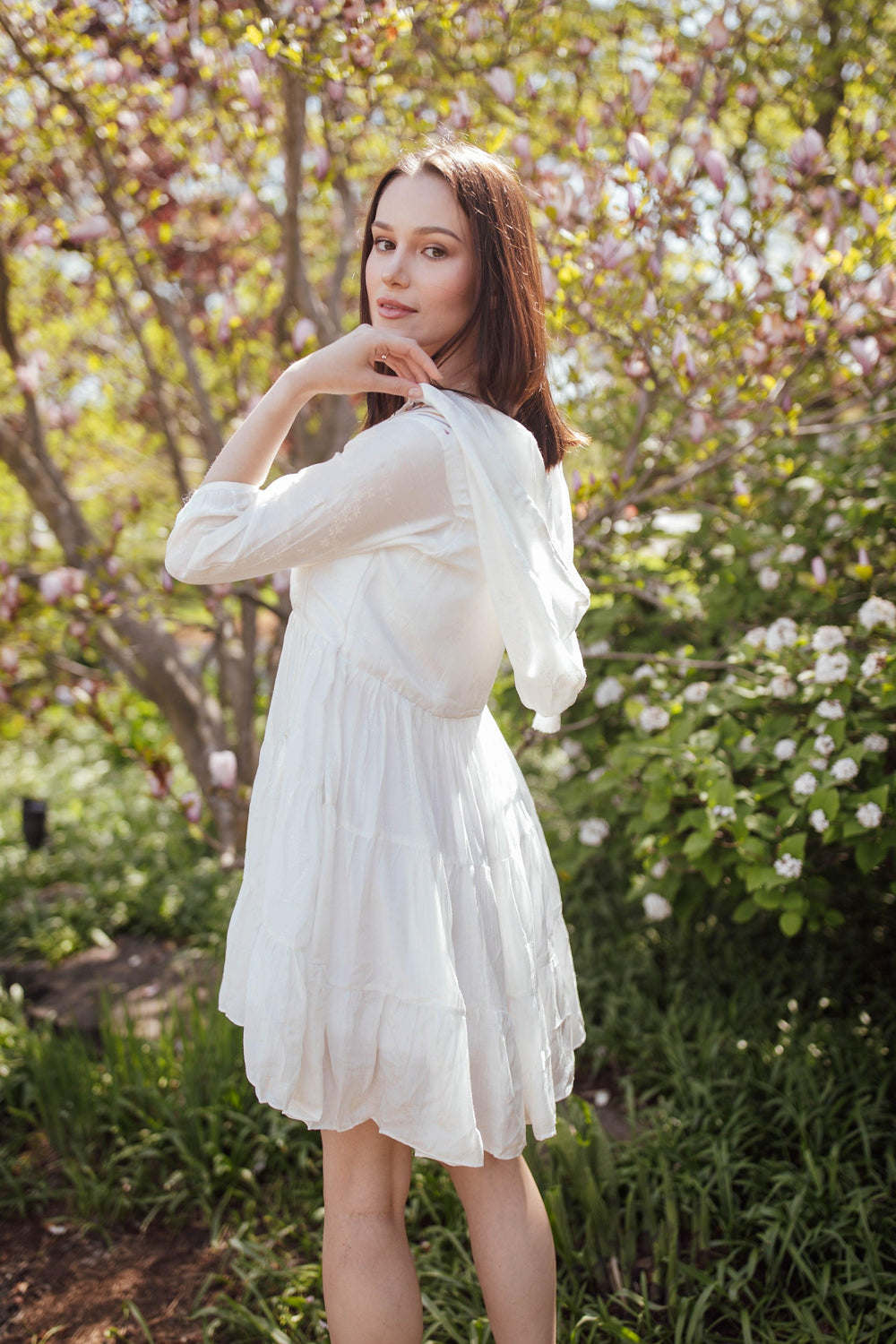 White cotton short dress with hood, tiered silhouette, and 3/4 sleeves, featuring resham embroidery.