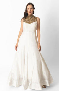White raw silk gown with heavily hand-embroidered gold high neckline and torso.