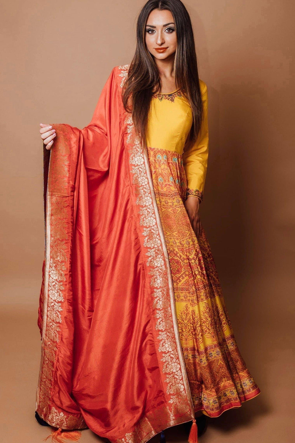 Yellow silk A-line gown with mustard bodice, traditional print skirt, and red georgette drape.