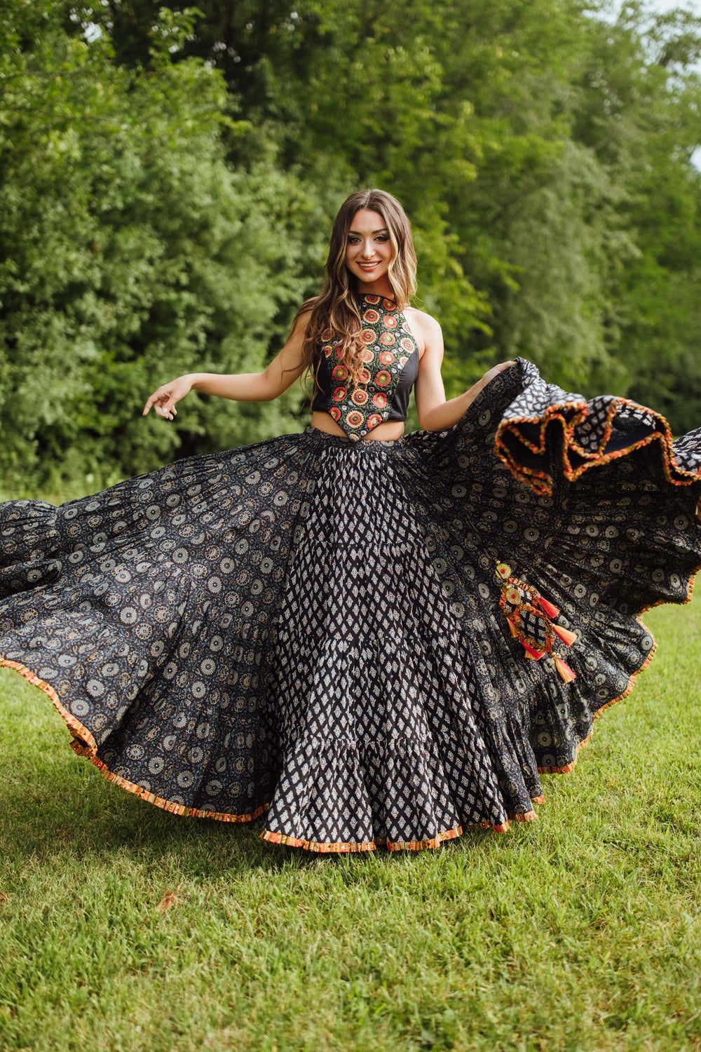 Woman in a blue full-flare cotton chaniya choli with embroidered blouse, dramatically twirling for Garba.