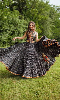 Woman in a blue full-flare cotton chaniya choli with embroidered blouse, dramatically twirling for Garba.