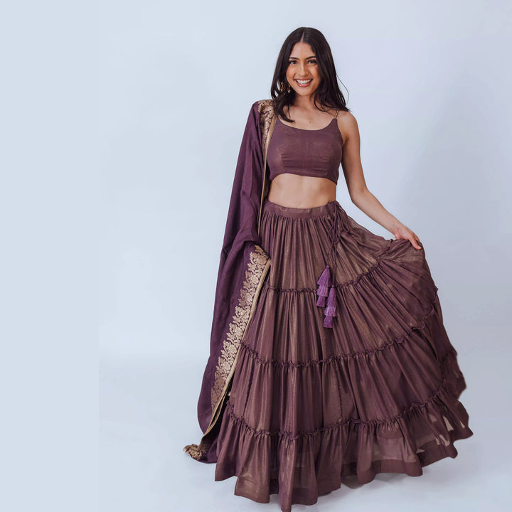 Gaia Brownish Purple Shimmer Tiered Lehenga set with Gold Accents