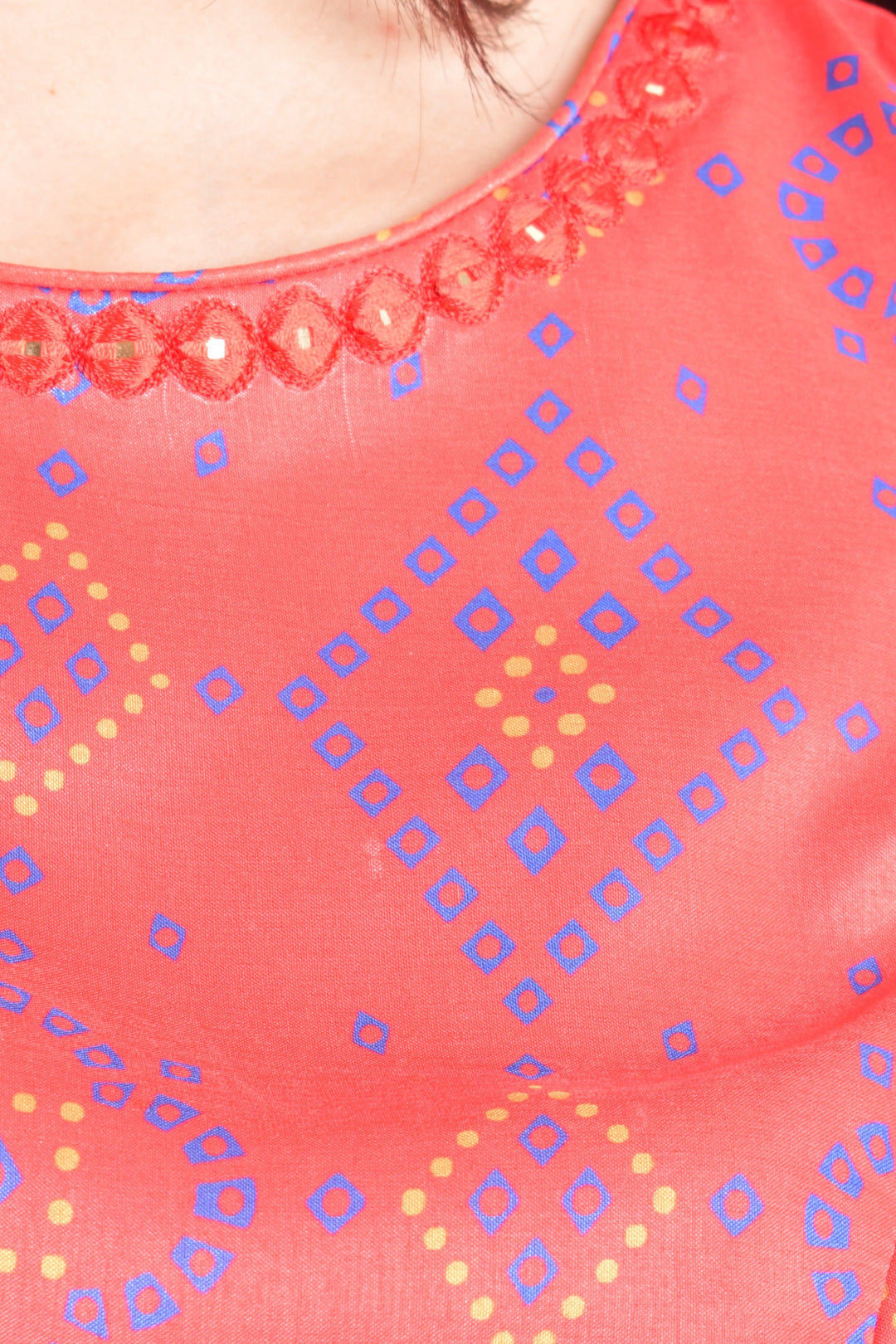 Close-up of a pink fabric with blue and yellow geometric patterns