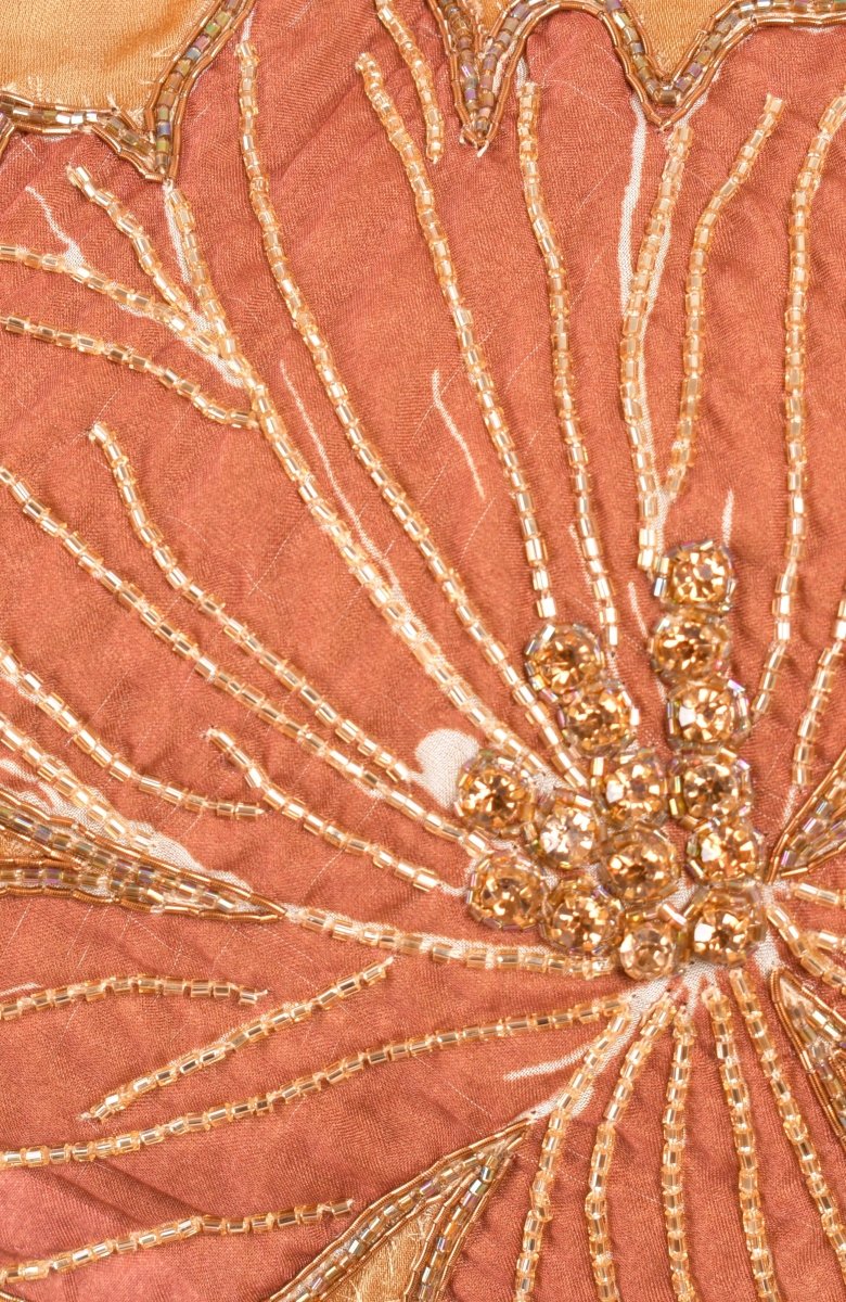 Close-up of gold Zardoshi and stone floral embroidery on the yellow lehenga choli