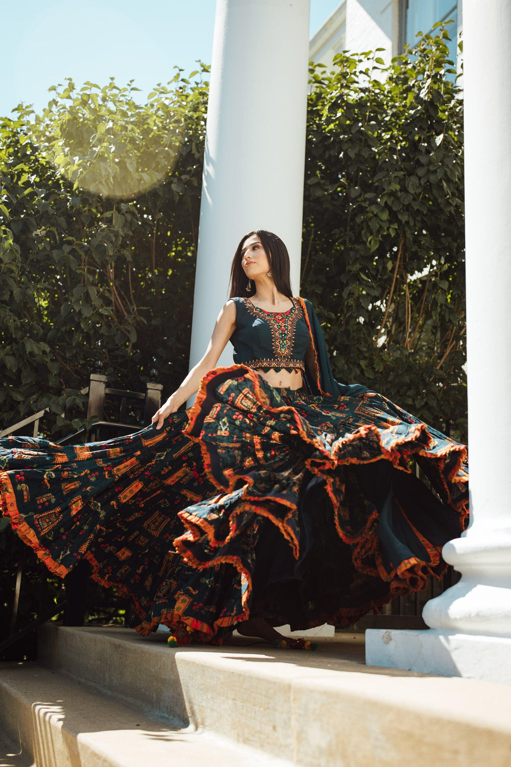 Woman in a full flare multi-color Chaniya Choli with ethnic prints, twirling for Garba.