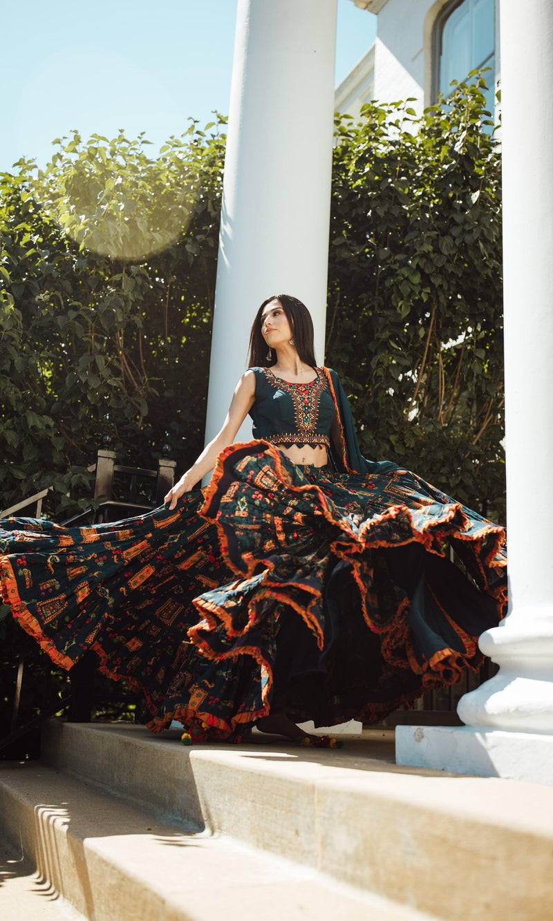 Woman in a full flare multi-color Chaniya Choli with ethnic prints, twirling for Garba.