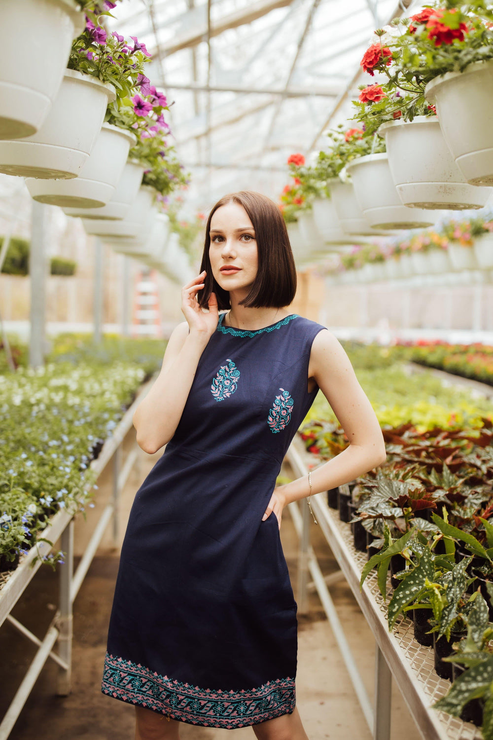 Navy cotton mini dress with hand block-printed patterns on neckline, torso, and hem.