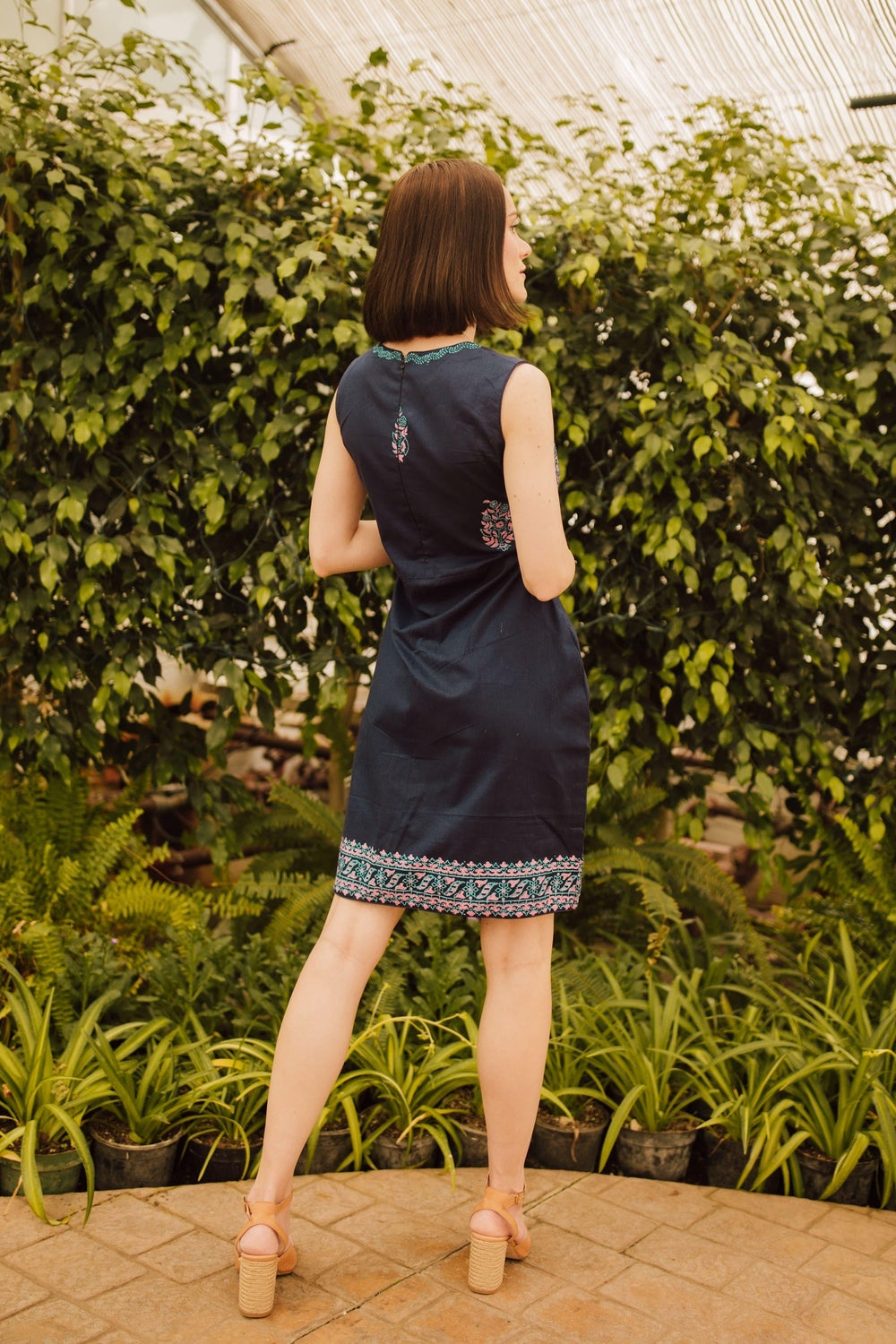 Navy cotton mini dress with block print, sleeveless, back zipper, shown from behind.