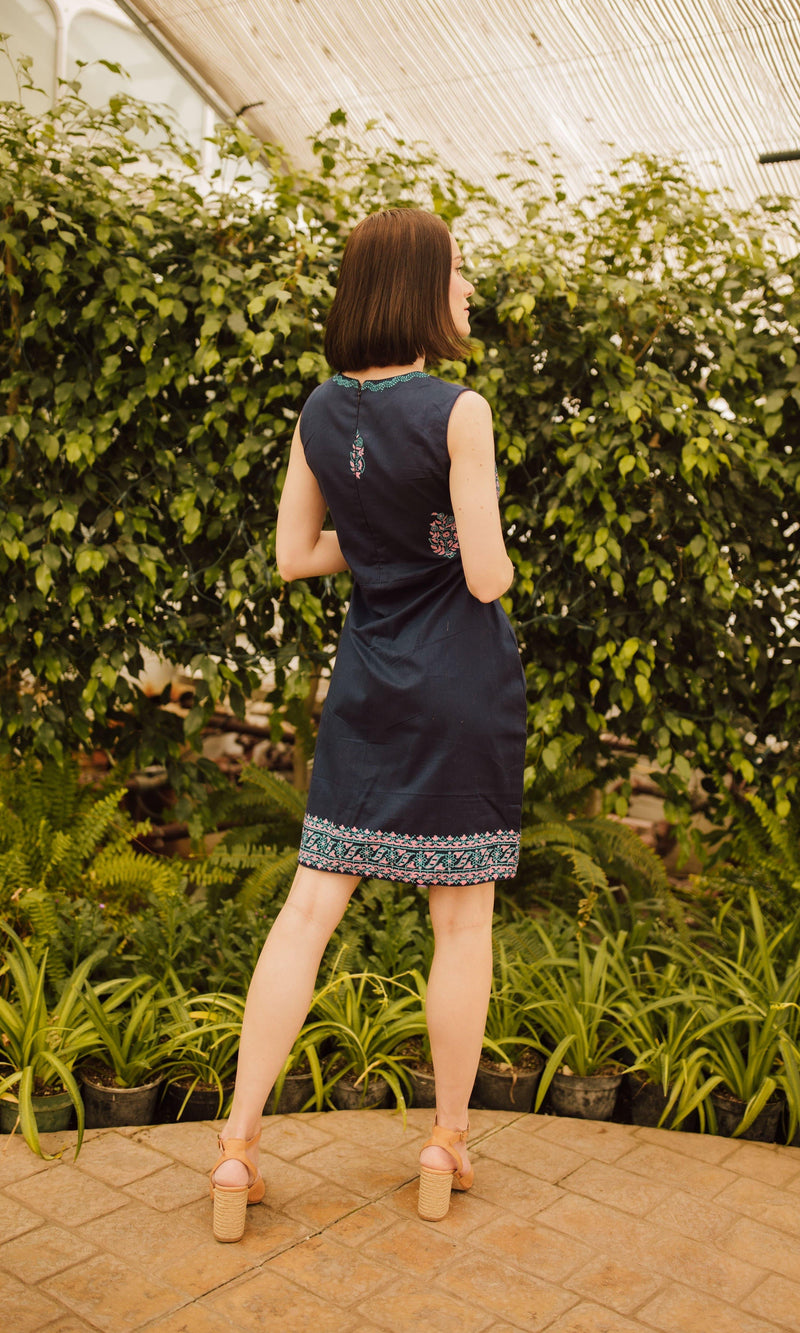 Navy cotton mini dress with block print, sleeveless, back zipper, shown from behind.