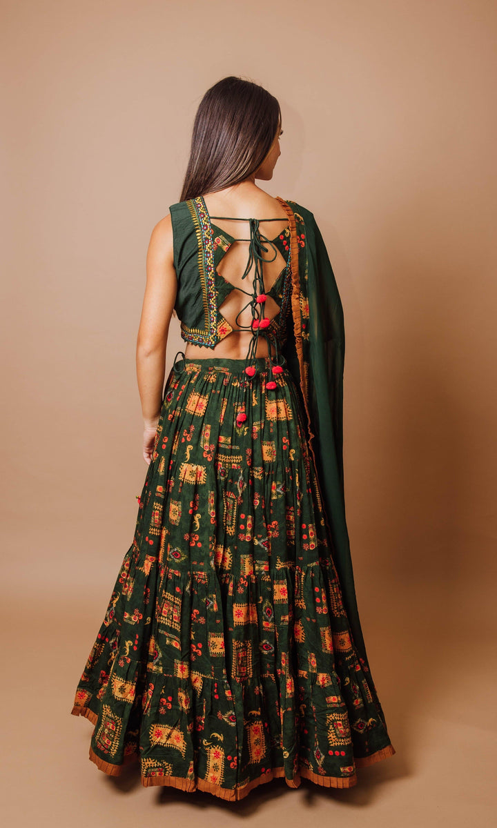 Green tiered rayon lehenga choli with open-back blouse, string ties, and dupatta. Perfect for Garba.