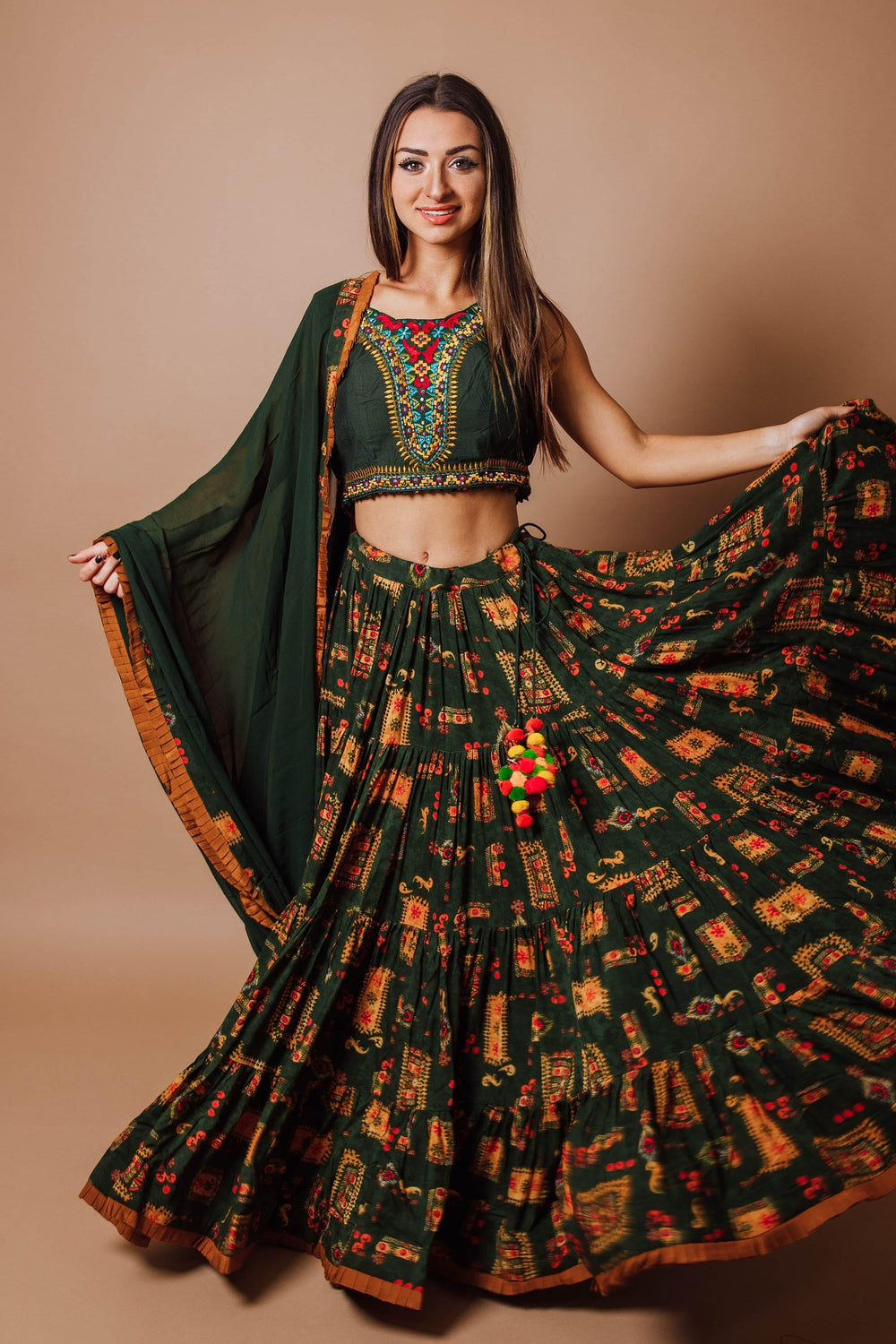 Green full flare tiered rayon lehenga choli set with hand embroidery, perfect for Garba styles.