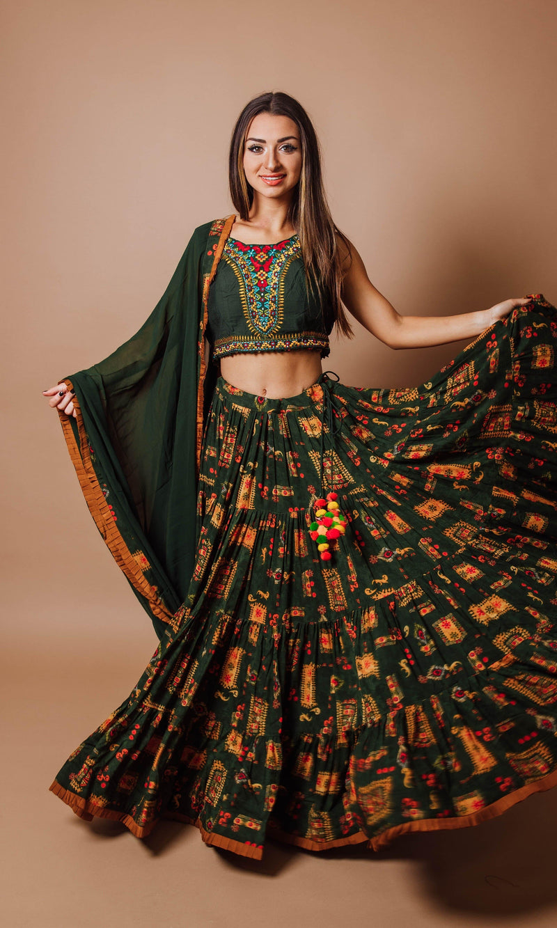 Green full flare tiered rayon lehenga choli set with hand embroidery, perfect for Garba styles.