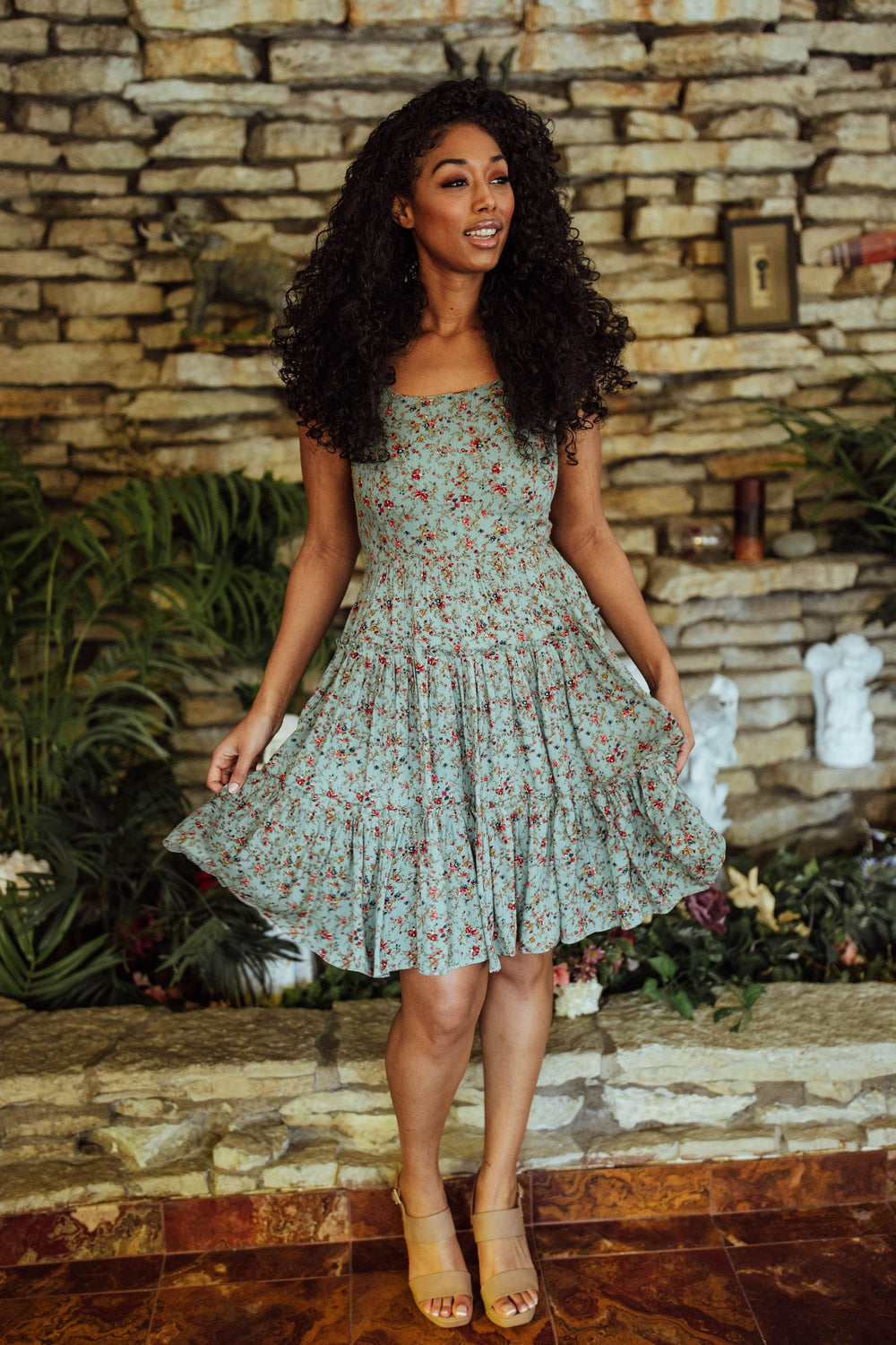 Green rayon tiered short dress with floral print, mini silhouette, and sleeveless design.