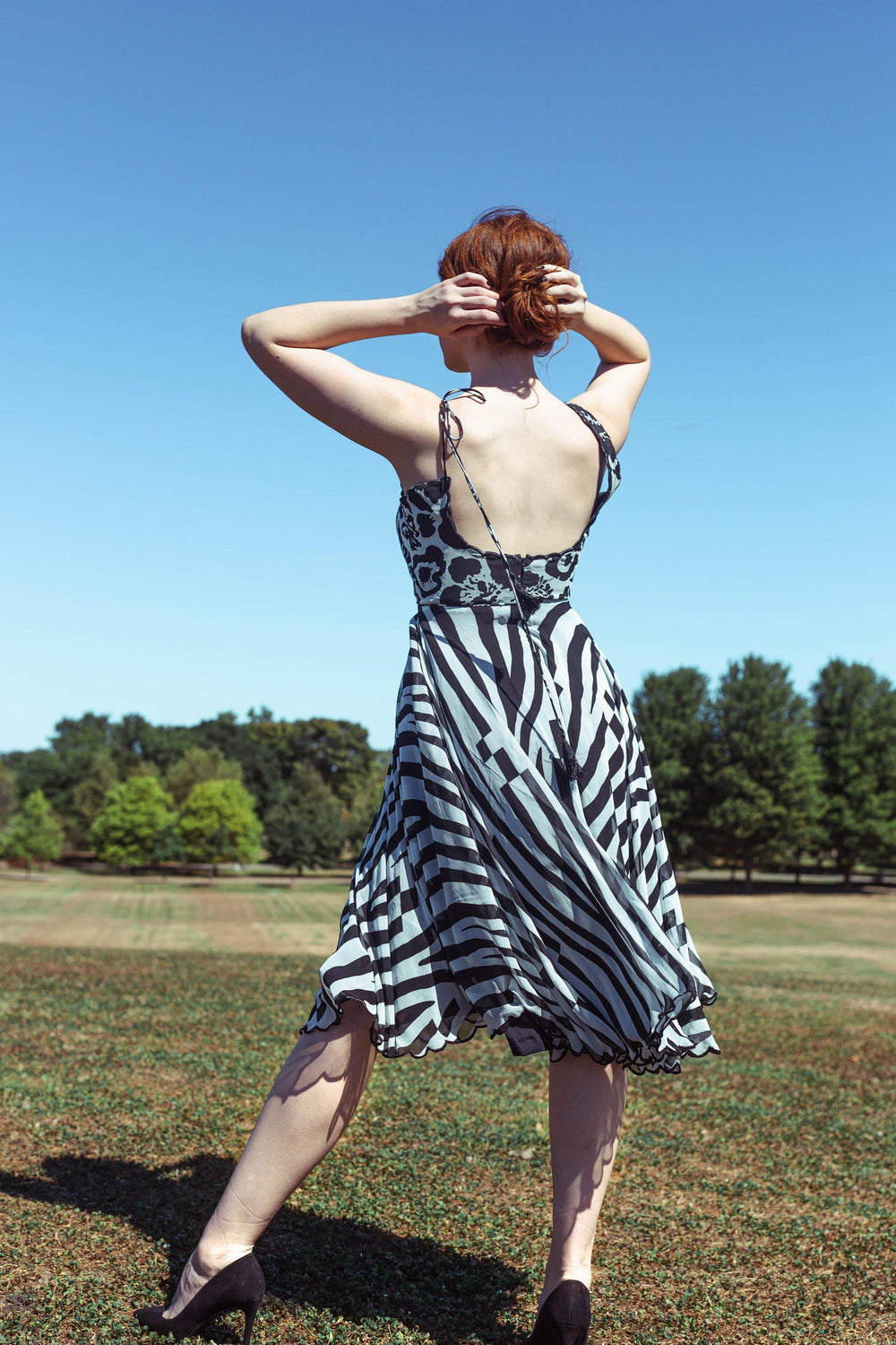 Grey georgette midi dress with black floral, paisley, and zebra prints, sleeveless, round neck.