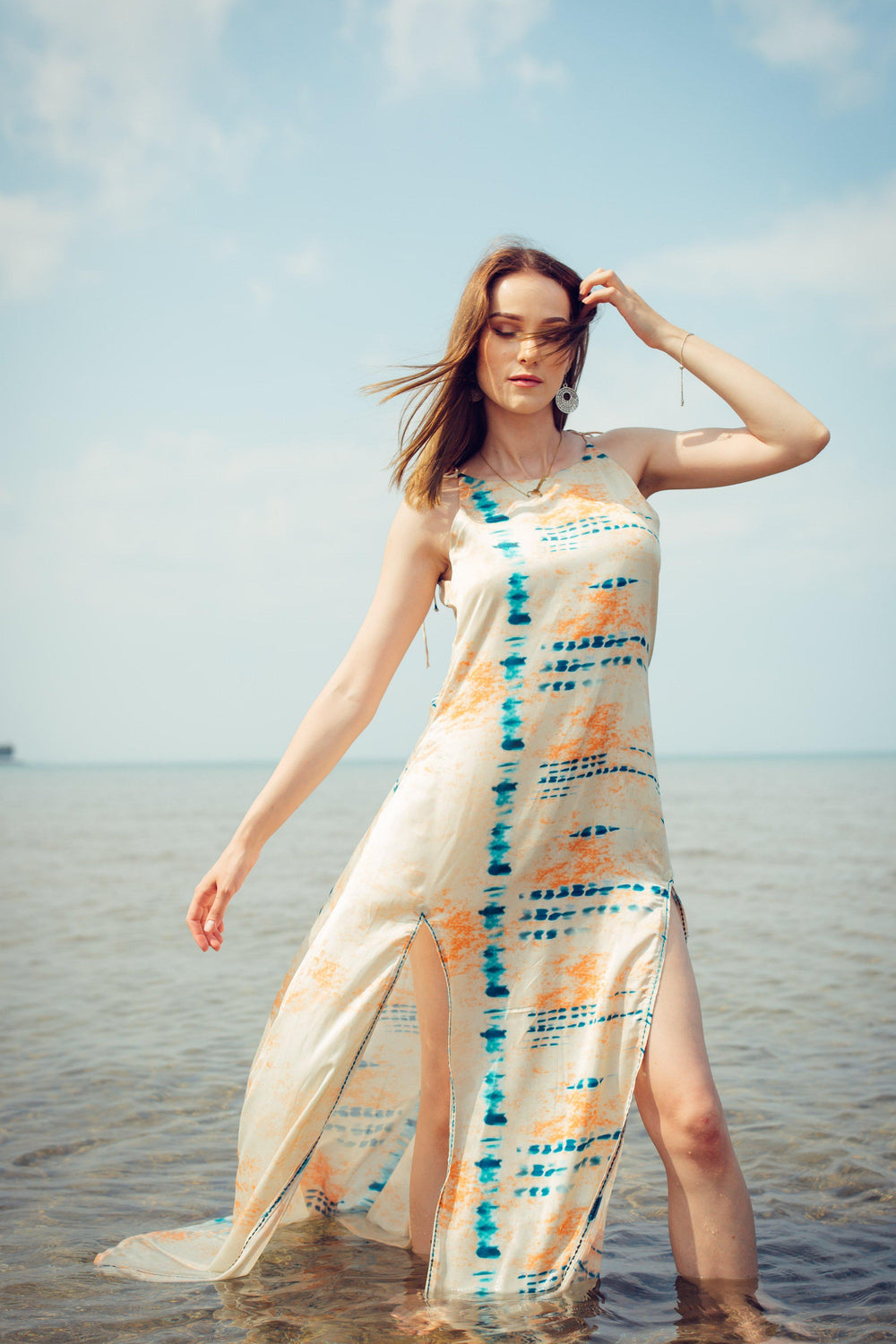 Off-white modal satin maxi dress with blue and orange tie-dye, double slits, and an embroidered belt.