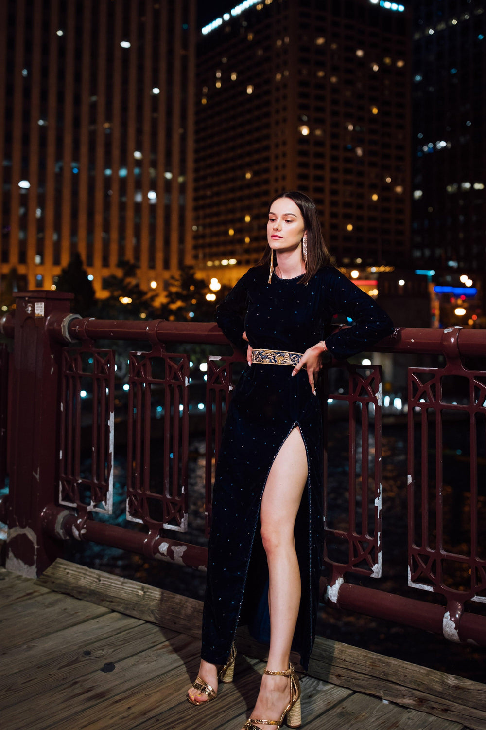 Deep navy velvet maxi dress with hand-embroidered stone work, ornate waistband, and left leg slit.