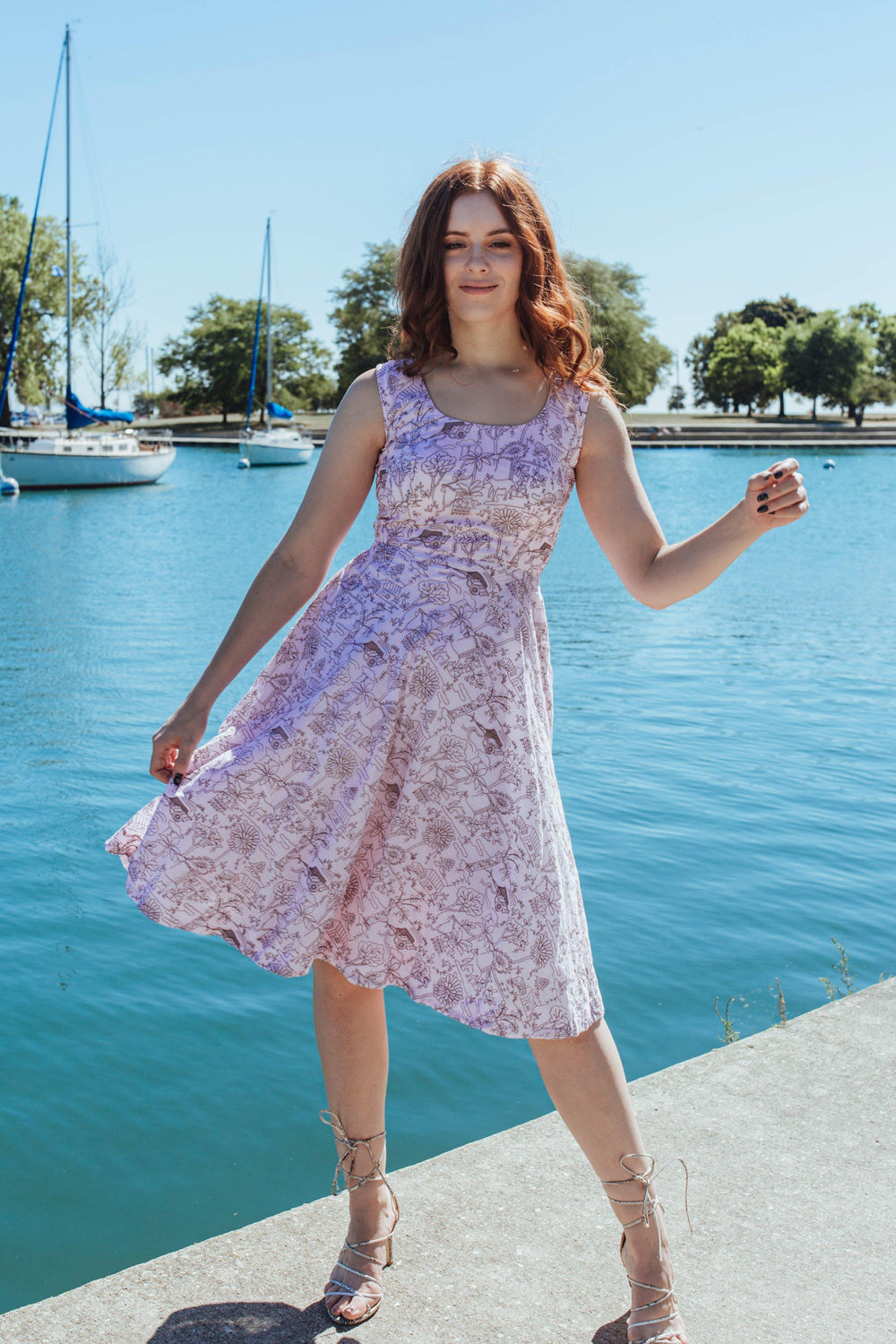 Pink mul cotton sleeveless midi dress with all-over thread embroidery, worn by a model outdoors.