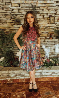 Sleeveless mini dress with red and gold embroidered bodice and colorful geometric-print circle skirt.