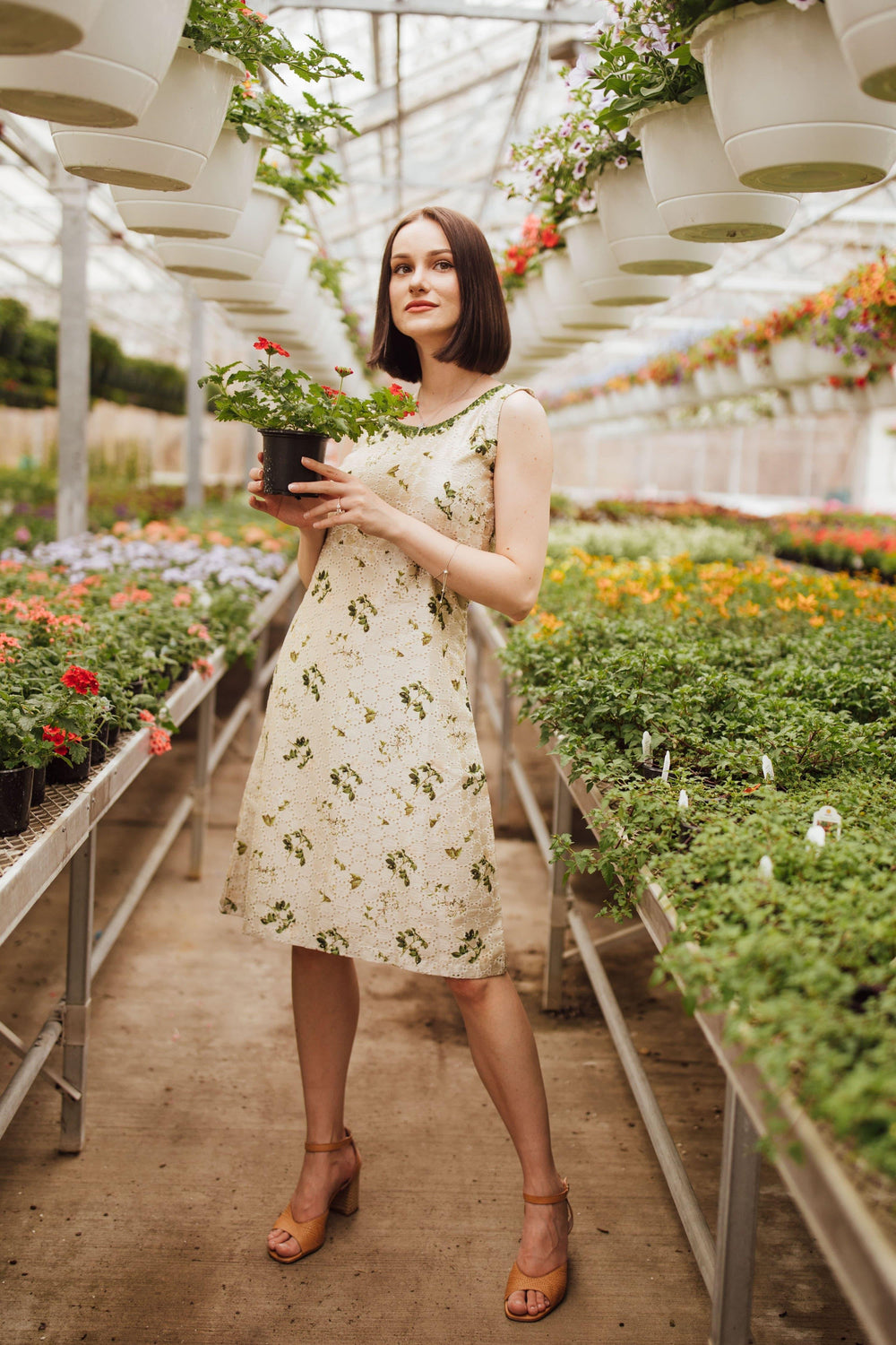 Off-white silk midi dress with all-over eyelet embroidery, sleeveless, and embroidered neckline.