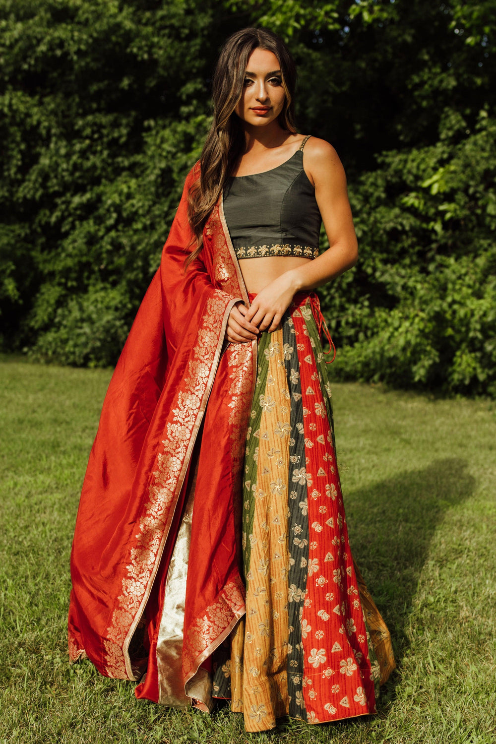 Zelie Silk Print Lehenga Choli: Woman in black blouse, multicolor silk chaniya, and red dupatta, ready for Garba.