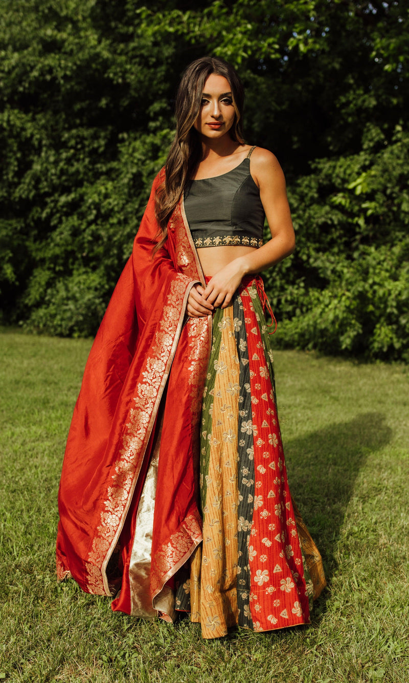 Zelie Silk Print Lehenga Choli: Woman in black blouse, multicolor silk chaniya, and red dupatta, ready for Garba.